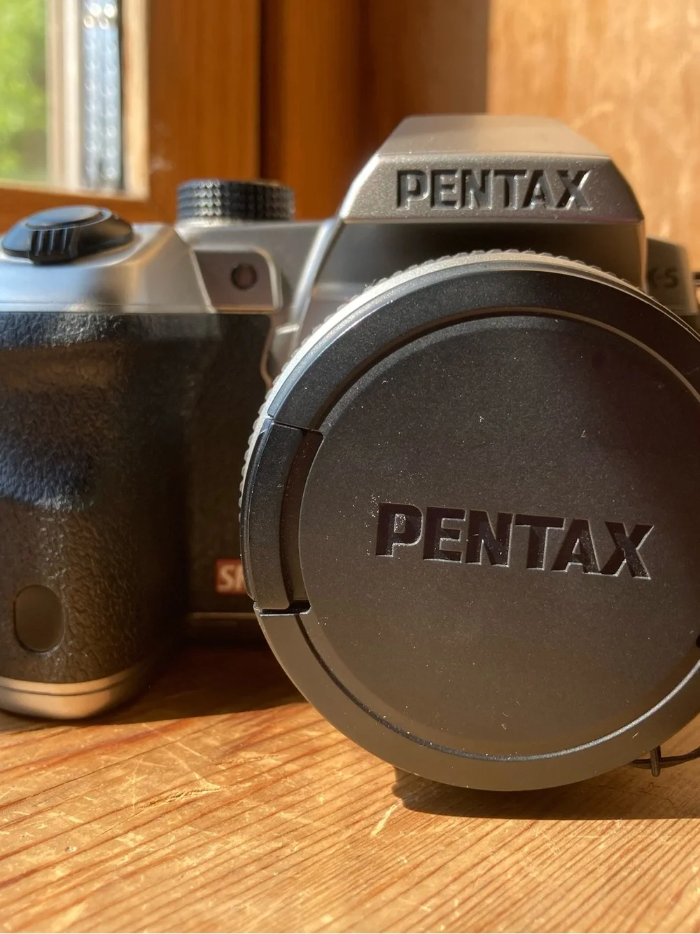 Pentax Black and Silver SLR Camera Body with Pentax Lens Cap